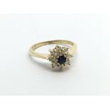An 18carat gold ring set with a blue sapphire a di