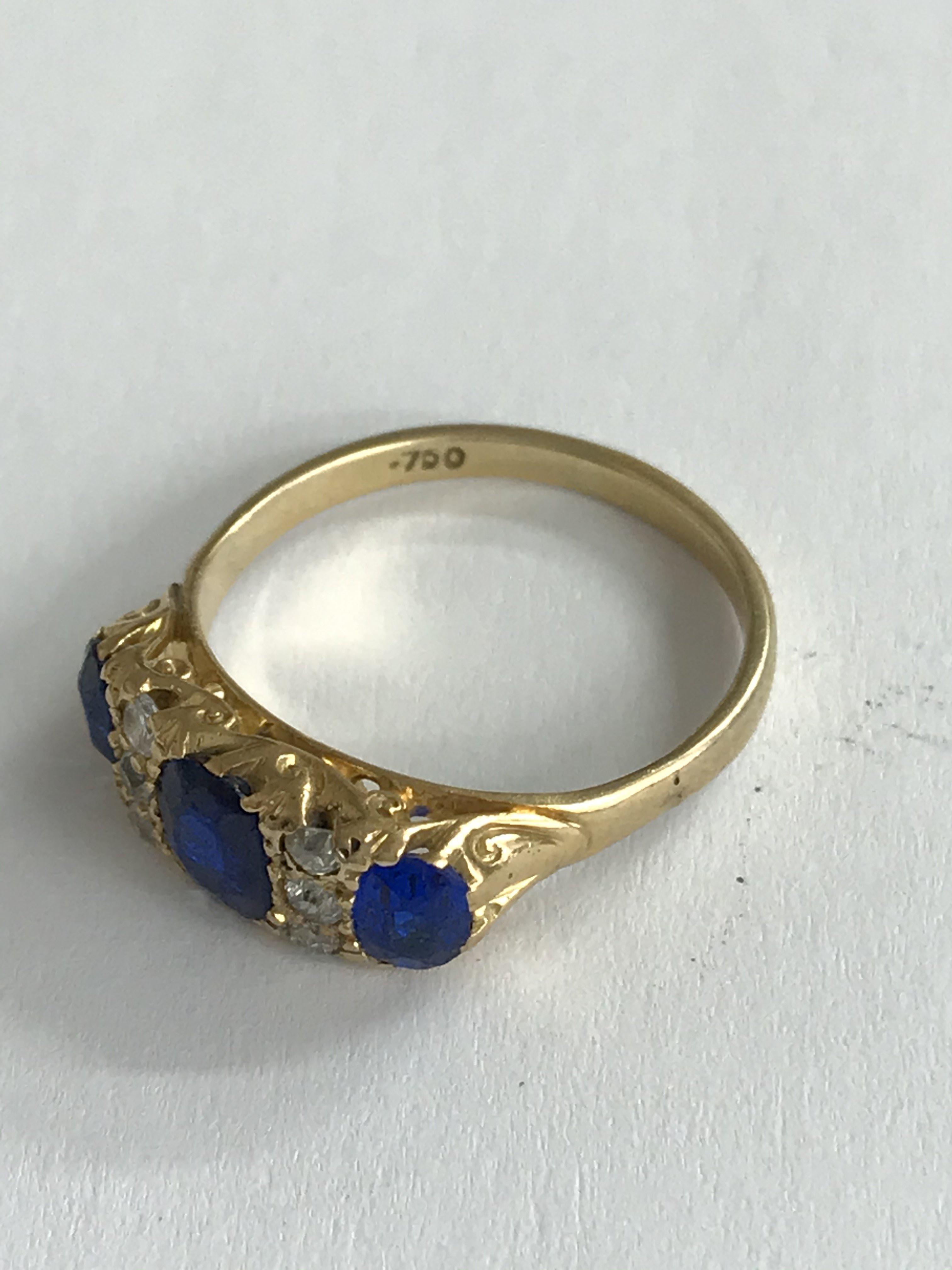 An 18ct gold diamond and blue stone set ring. (p).
