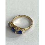 An 18ct gold diamond and blue stone set ring. (p).