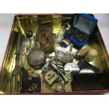 A tin of oddments including a letter opener, caddy