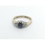 A 9carat gold ring set with a sapphire and flanked