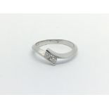 An 18carat white gold ring set with two brilliant