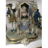 A porcelain figure group in the form of a maiden in a sedan chair 38 cm