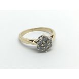 An 18carat gold ring set with a pattern of seven diamonds. ring size M