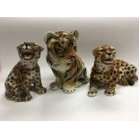 Three ceramic figures of big cats comprising a tig