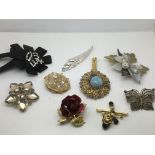 Ten costume brooches including a paste crown, fili