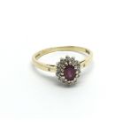 An 18carat gold ring set with a ruby and flanked b
