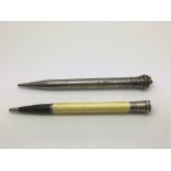 Two silver plated pencils, one set with engine tur