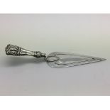 A silver bookmark in the form of a trowel, approx