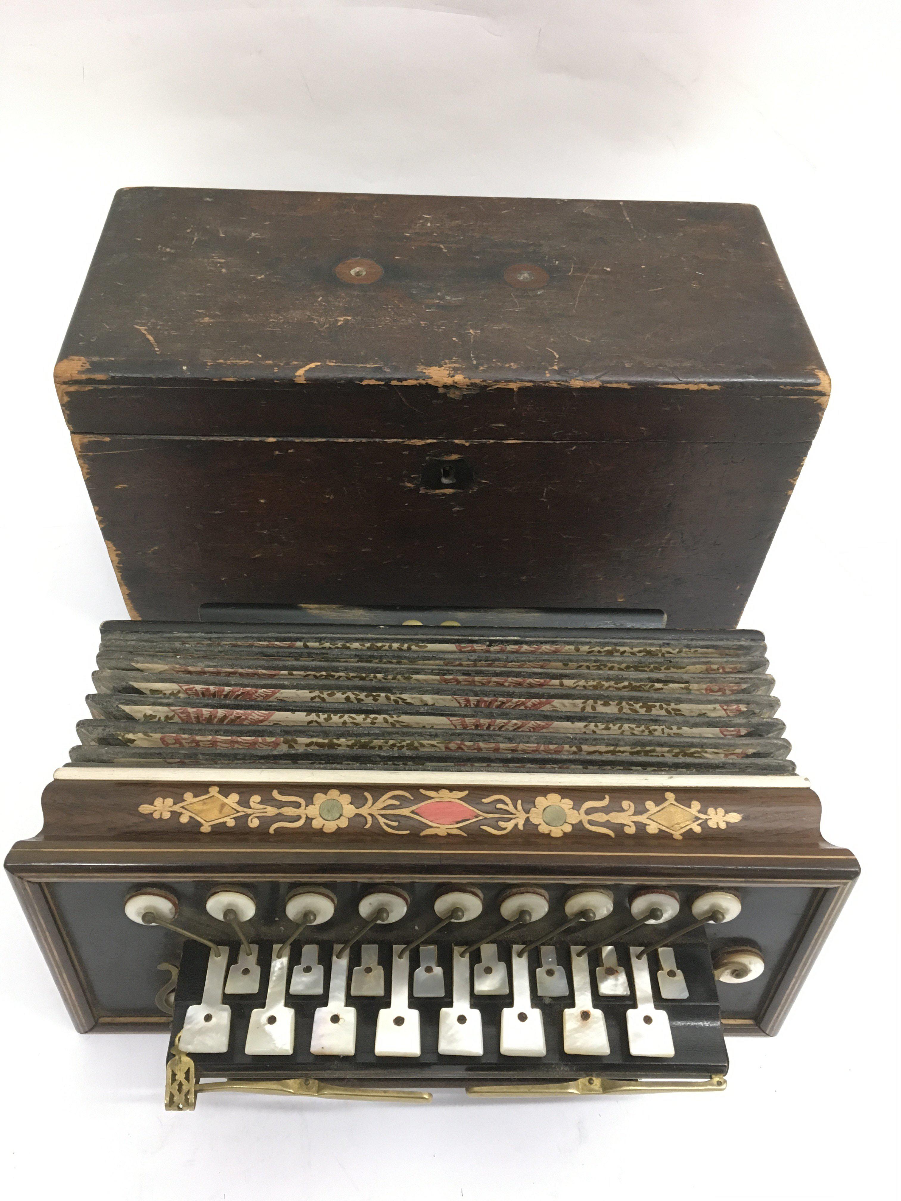 A wooden cased French Flutina accordion with mother of pearl keys and painted decoration.Approx