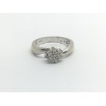 An 18carat white gold ring set with a pattern of b