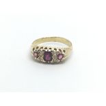 A Vintage gold ring set with three ruby and small diamonds ring size M-N