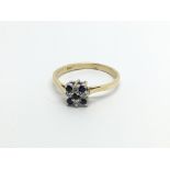 An 18carat gold ring set with a square pattern of