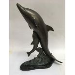 A brass ornament in the form of a dolphin. 42 cm