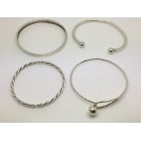 Four silver bangles.