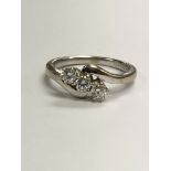 An 18 ct white gold diamond ring set with three br