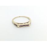 A 9carat gold ring set with three section single r
