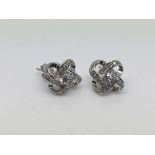 A pair of silver and clear stone Celtic knot earri