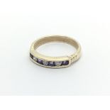 A 9carat golf half hoop eternity ring set with alternating amethyst and brilliant cut diamonds