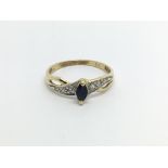 An 18carat gold ring set with a sapphire flanked b