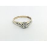 A 9carat gold ring set with a central solitaire di