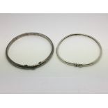 Two silver bangles.