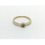 An 18carat gold ring set with a round pattern of d