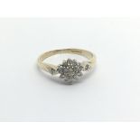 A 9carat gold ring set with a pattern of diamonds