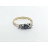 An unmarked gold ring set with a blue Sapphire fla