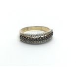 A 9carat gold ring set with a row of black diamond