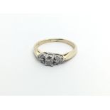 A 14carat gold ring set with a pattern of diamonds ring size J.