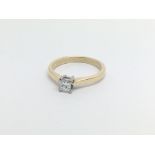 An 18carat gold ring set with a princess cut diamo