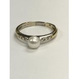 A 18 ct gold ring set with a single pearl the shan