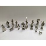 A collection of heavy silver plated figures of Victorian market traders and others, the largest