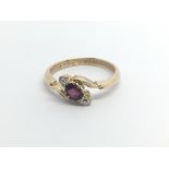 A Vintage 18carat gold ring set with a ruby flanked by two brilliant cut diamonds ring size O.