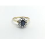 An 18carat gold ring set with a central sapphire f