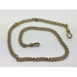 An antique gold plated watch chain and two fob cli