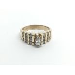 A 14carat gold ring set with a central marques diamond flanked by vertical rows of brilliant cut