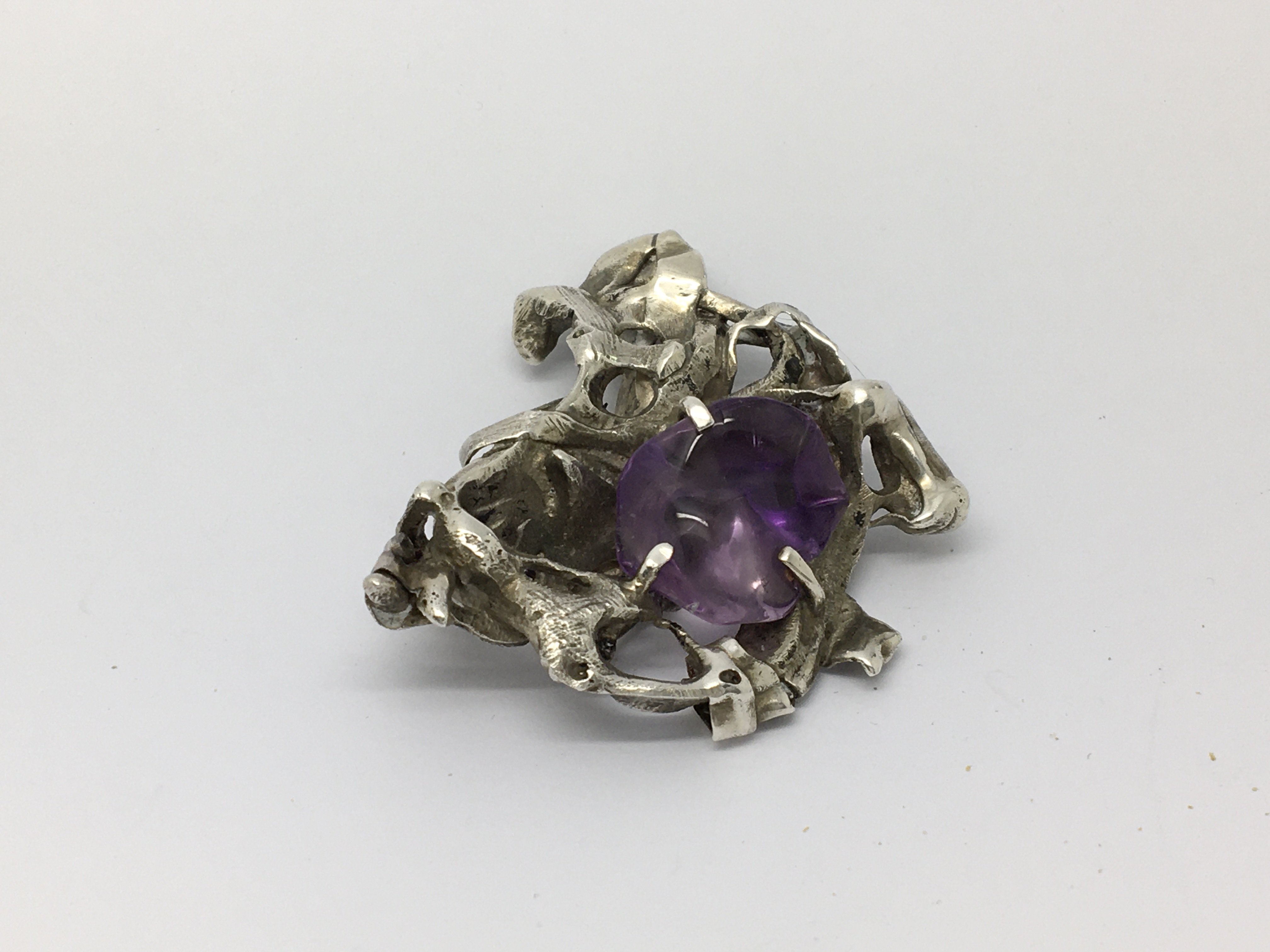 A large heavy silver and natural polished amethyst