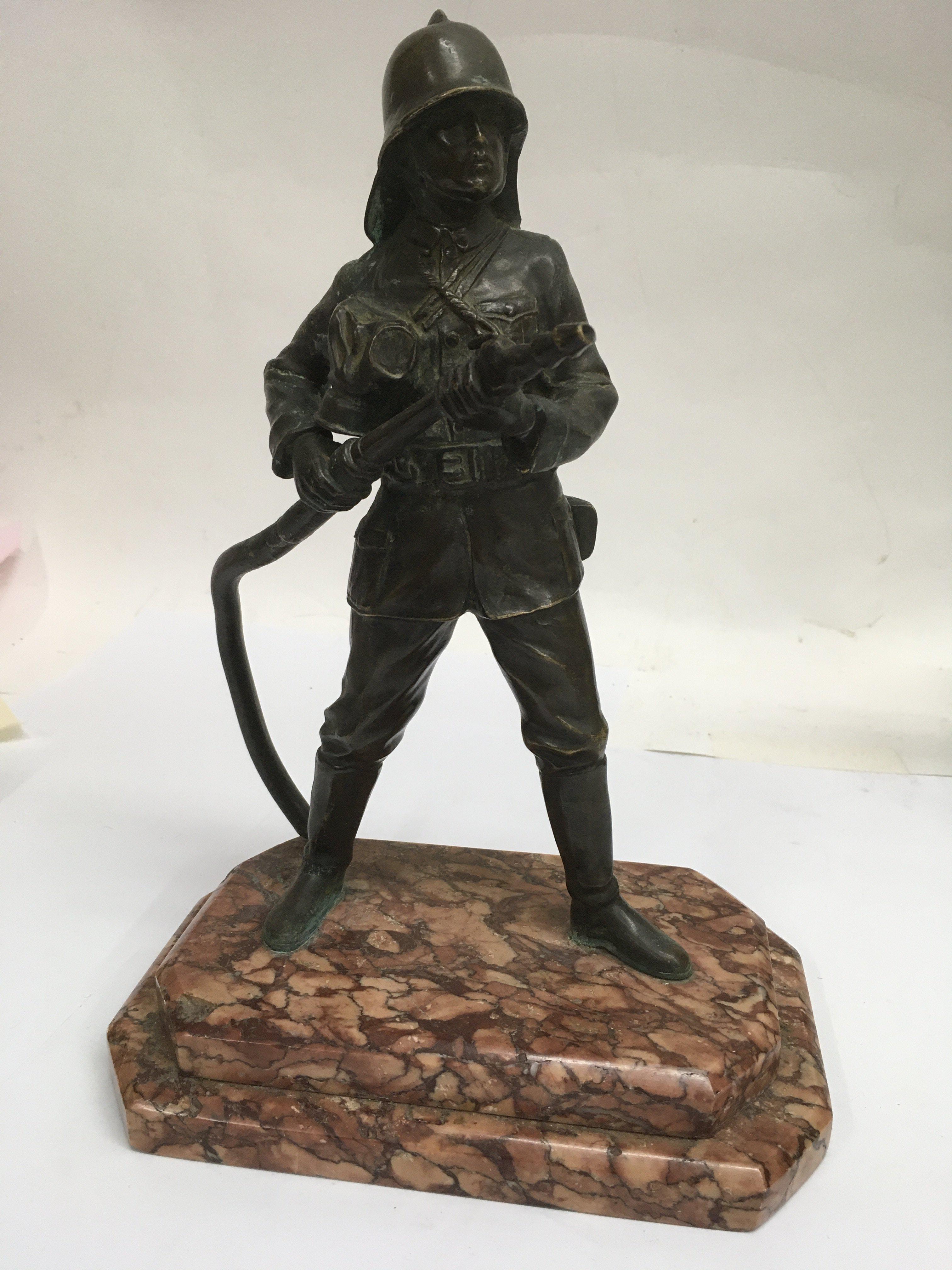 A Art Deco bronze figure in the form of a fireman