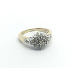 A 9carat gold ring set with a cluster pattern of diamonds ring size I.