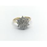 An 18carat gold ring set with a cluster of diamonds ring size J-K