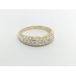 A 9carat gold ring set with a row of CZ ring size
