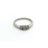 A 9carat white gold ring set with three princess c