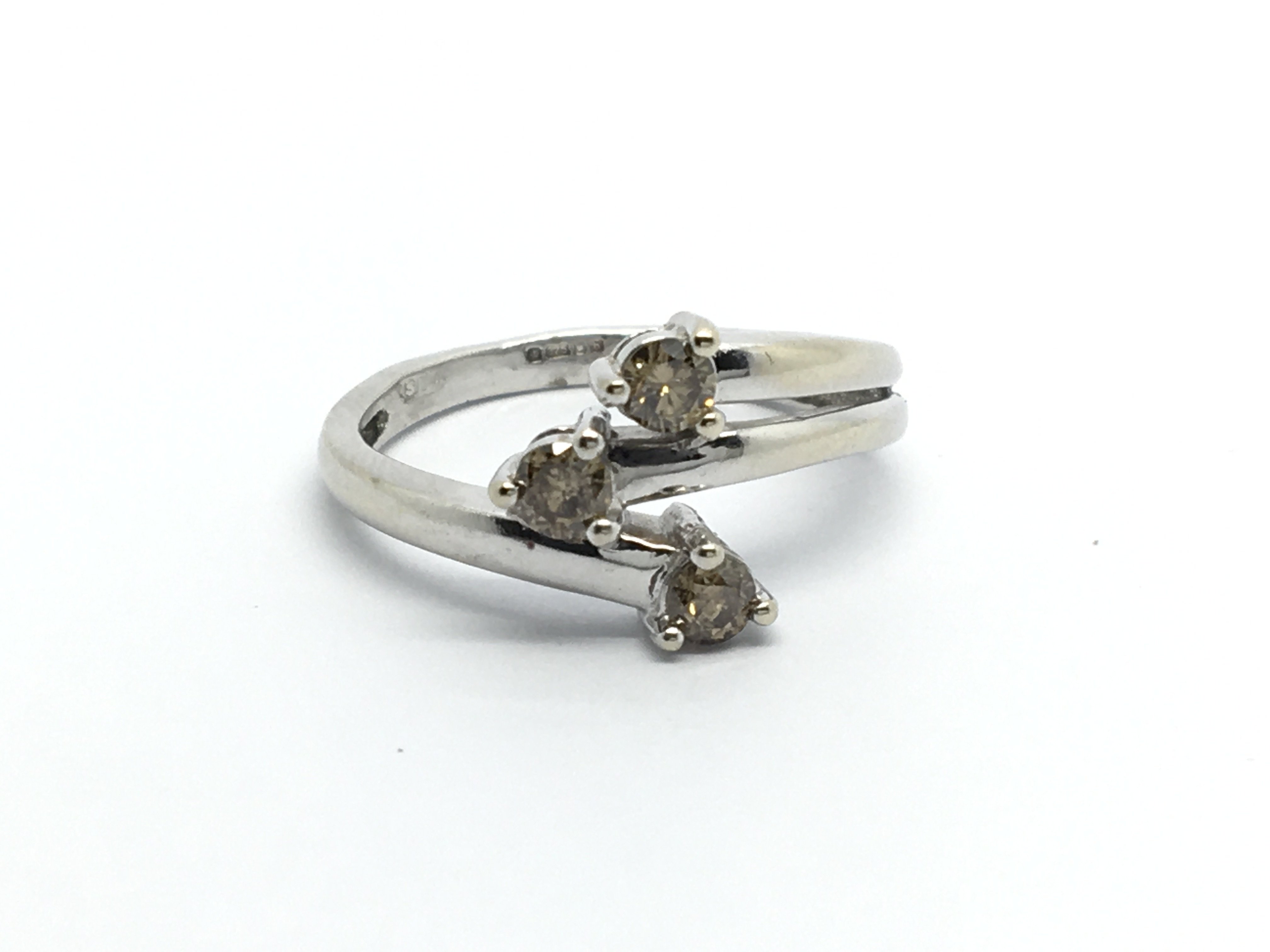 A modern design 9carat white gold ring set with ch