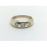 A 9carat gold Gypsy type ring set with three diamo