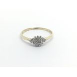 A 9carat gold ring set with a pattern of diamonds