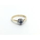 An 18carat gold sapphire and diamond cluster ring size J-K