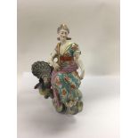 A 19 th century porcelain figure in the form Hera seated in chariot flanked By a peacock. 27 cm