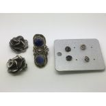 Three pairs of silver earrings and a silver ring s